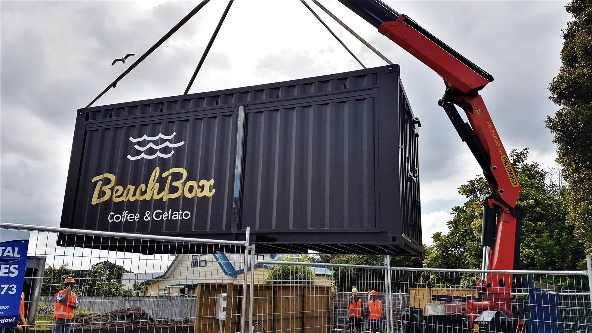 The BeachBox shipping container being lowered onto the site by crane