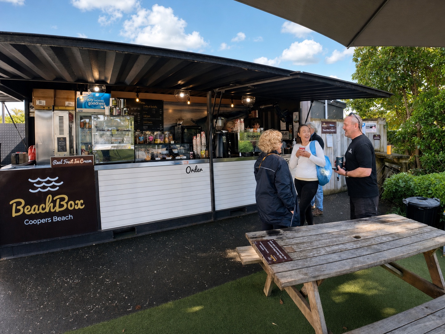 Conversation between the BeachBox team and customers outside the coffee shop